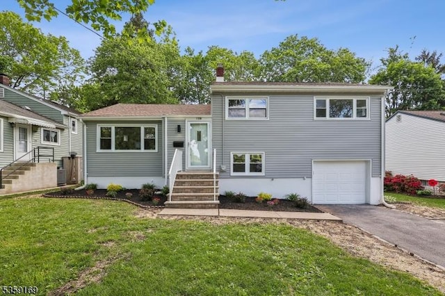 158 Old Indian Rd, West Orange Twp, NJ 07052 - split level home featuring entry steps, asphalt driveway, a chimney, a garage, and a front lawn