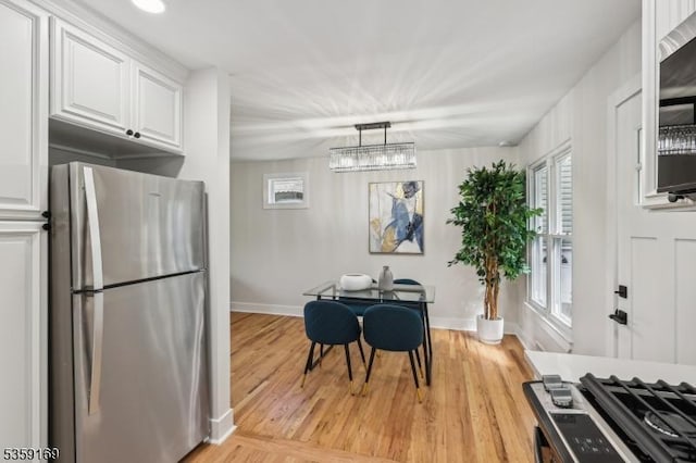 158 Old Indian Rd, West Orange Twp, NJ 07052 - dining room featuring healthy amount of natural light, baseboards, light wood-style floors, and a chandelier