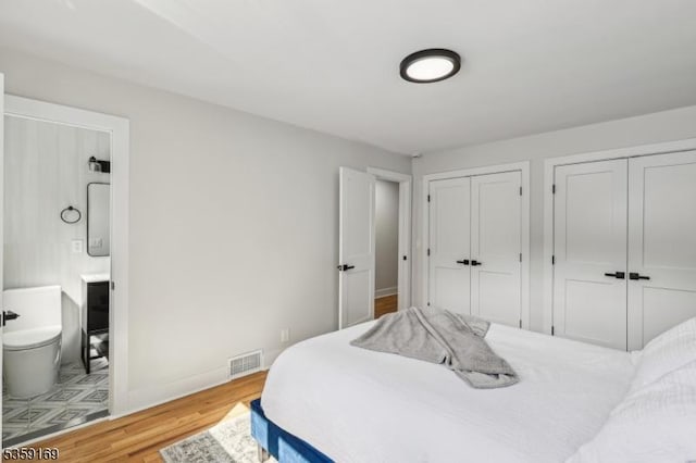 158 Old Indian Rd, West Orange Twp, NJ 07052 - bedroom with multiple closets, wood finished floors, ensuite bath, and baseboards
