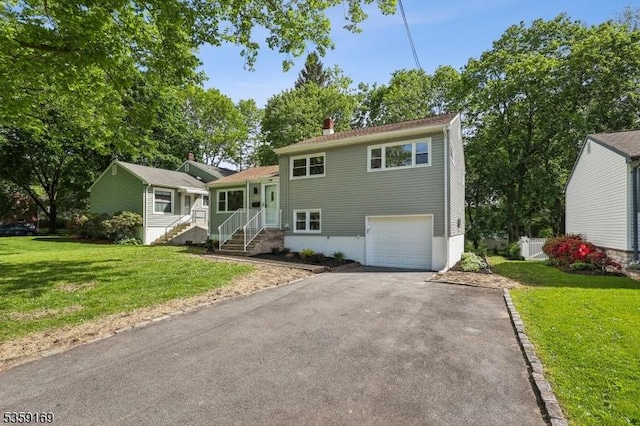 158 Old Indian Rd, West Orange Twp, NJ 07052 - split level home featuring driveway, a garage, a front lawn, and a chimney