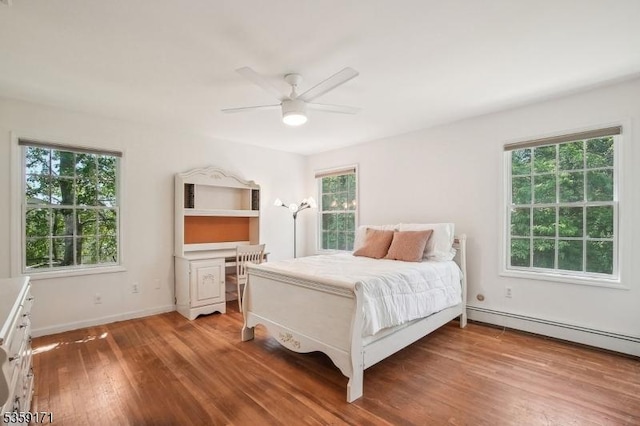 9 Baker Rd, Livingston Twp, NJ 07039 - bedroom featuring light wood-style floors, multiple windows, a baseboard heating unit, and baseboards