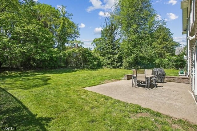 9 Baker Rd, Livingston Twp, NJ 07039 - view of grassy yard with a patio
