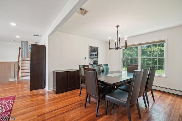 9 Baker Rd, Livingston Twp, NJ 07039 - dining space with a chandelier, stairway, light wood-type flooring, baseboard heating, and recessed lighting