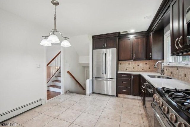 9 Baker Rd, Livingston Twp, NJ 07039 - kitchen with high end refrigerator, baseboard heating, tasteful backsplash, a sink, and dark brown cabinets