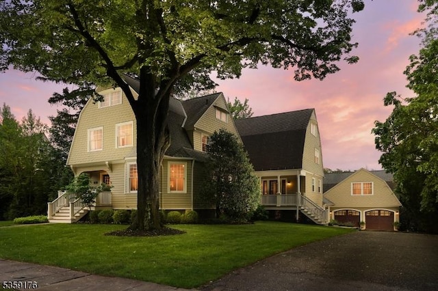 216 Kimball Ave, Westfield Town, NJ 07090 - colonial inspired home with a gambrel roof, stairway, a garage, and a front lawn