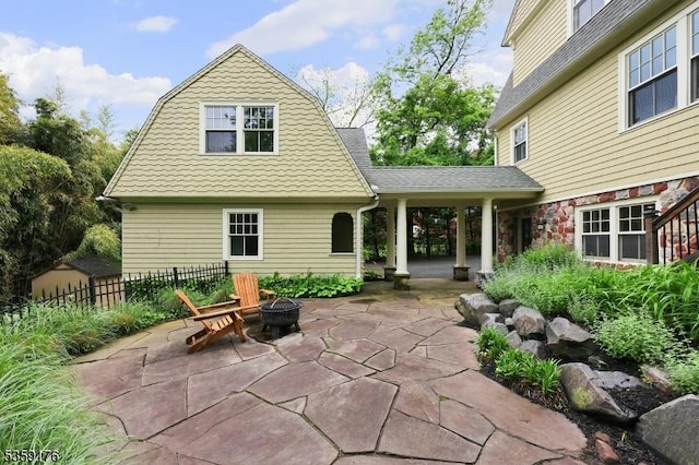 216 Kimball Ave, Westfield Town, NJ 07090 - back of property featuring a fire pit, a patio area, and a gambrel roof