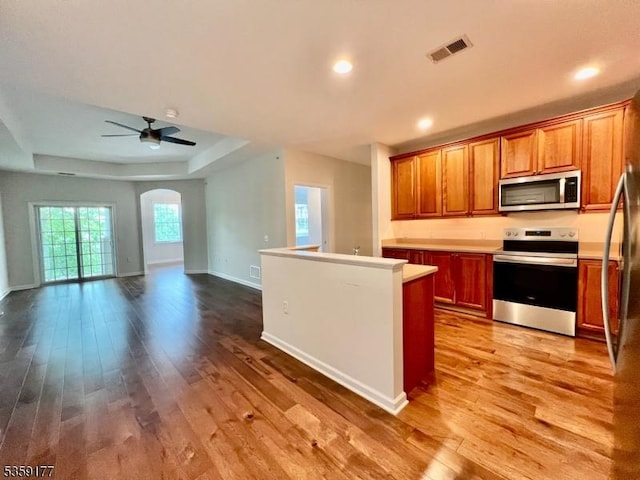 24 Ridgeview Ln Unit 24, Mount Arlington Boro, NJ 07856 - kitchen with stainless steel appliances, wood finished floors, arched walkways, ceiling fan, and recessed lighting