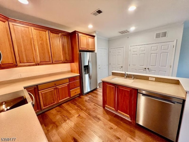 24 Ridgeview Ln Unit 24, Mount Arlington Boro, NJ 07856 - kitchen with appliances with stainless steel finishes, a sink, crown molding, wood finished floors, and light countertops