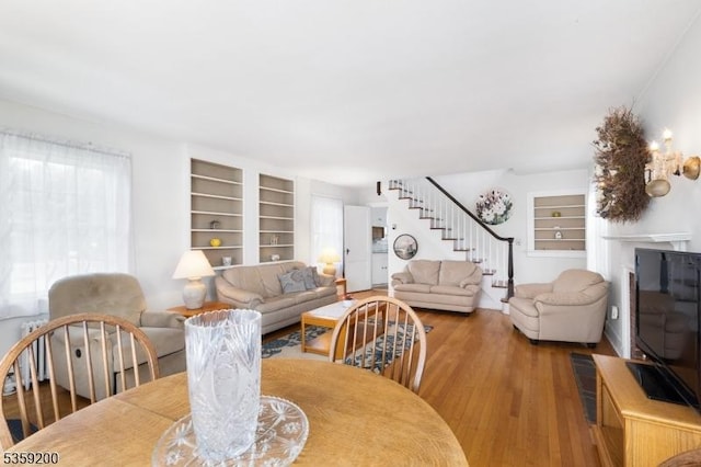 20 Kenvil Ave, Roxbury Twp, NJ 07876 - dining space featuring built in shelves, stairs, and hardwood / wood-style floors