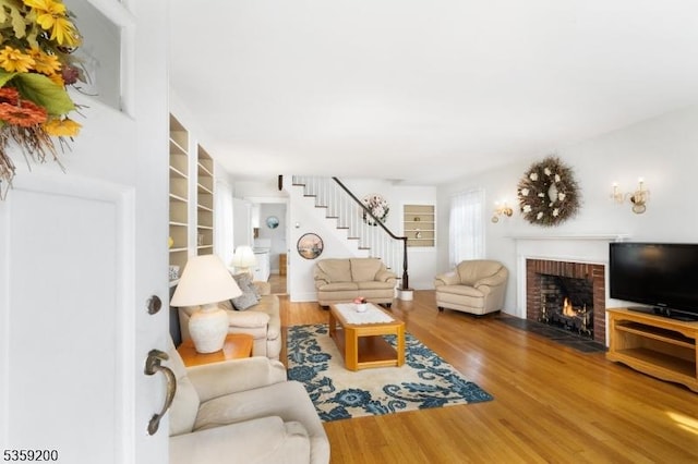 20 Kenvil Ave, Roxbury Twp, NJ 07876 - living room featuring a brick fireplace, wood finished floors, and stairs
