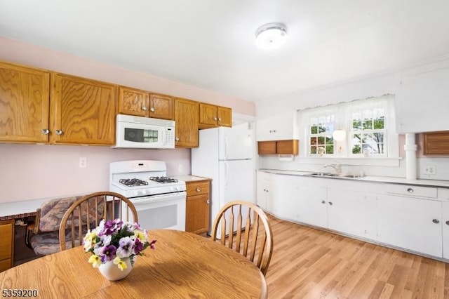 20 Kenvil Ave, Roxbury Twp, NJ 07876 - kitchen featuring white appliances, a sink, light countertops, light wood-style flooring, and brown cabinetry