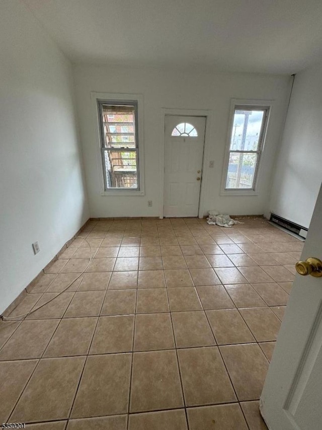 653 4th Ave, Elizabeth City, NJ 07202 - entryway with light tile patterned floors and a baseboard radiator