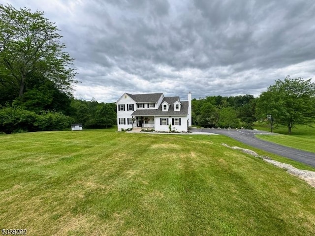 14 Thomas Rd, Lafayette Twp, NJ 07848 - view of front facade with a chimney, a front yard, and covered porch