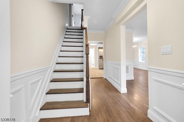 179 Berkeley Ave, Berkeley Heights Twp, NJ 07922 - stairs featuring ornamental molding, wood finished floors, a wainscoted wall, and a decorative wall