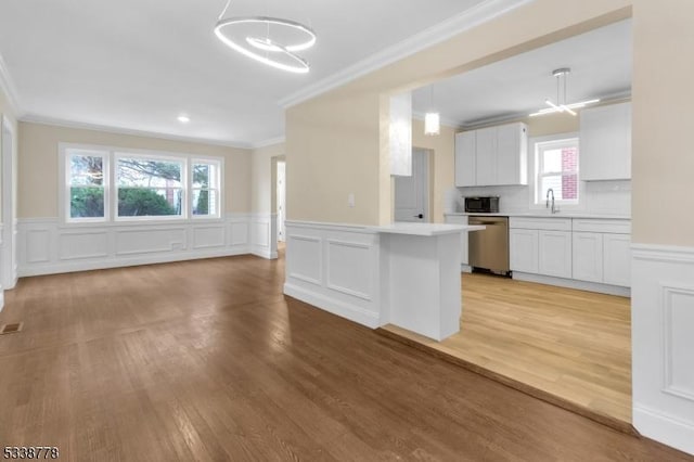 179 Berkeley Ave, Berkeley Heights Twp, NJ 07922 - kitchen with stainless steel dishwasher, ornamental molding, a chandelier, light countertops, and white cabinetry