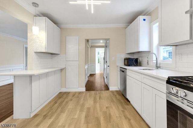 179 Berkeley Ave, Berkeley Heights Twp, NJ 07922 - kitchen featuring stainless steel appliances, a sink, ornamental molding, light countertops, and light wood-style floors