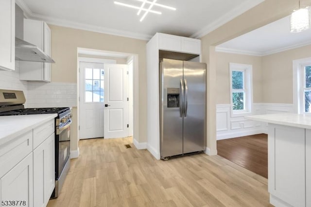 179 Berkeley Ave, Berkeley Heights Twp, NJ 07922 - kitchen featuring appliances with stainless steel finishes, plenty of natural light, light wood-style floors, crown molding, and light countertops