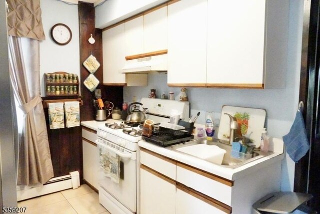 115 Navesink Ave, Highlands Boro, NJ 07732 - kitchen featuring white gas stove, under cabinet range hood, baseboard heating, light countertops, and white cabinetry