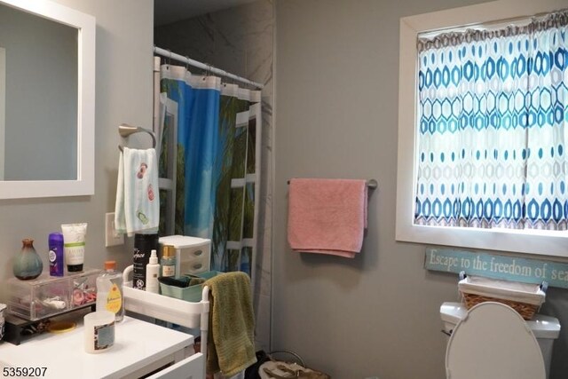 115 Navesink Ave, Highlands Boro, NJ 07732 - bathroom with toilet, healthy amount of natural light, vanity, and a shower with shower curtain