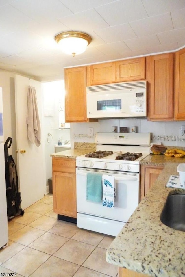 115 Navesink Ave, Highlands Boro, NJ 07732 - kitchen featuring white appliances, light tile patterned floors, and light stone counters