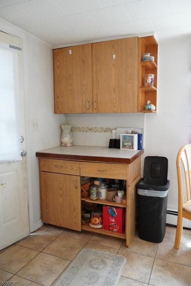 115 Navesink Ave, Highlands Boro, NJ 07732 - kitchen with open shelves, light tile patterned flooring, backsplash, and light countertops