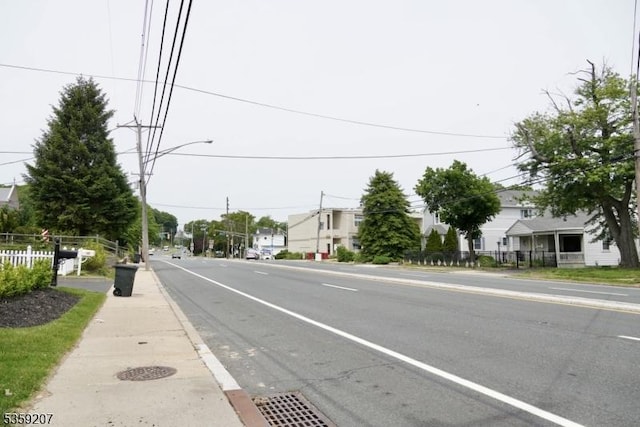 115 Navesink Ave, Highlands Boro, NJ 07732 - view of asphalt road featuring street lights, sidewalks, and curbs