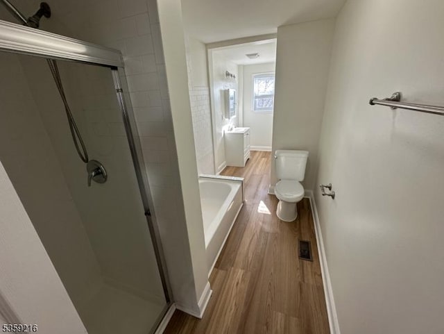 151 Sutton Ave, Totowa Boro, NJ 07512 - bathroom with wood finished floors, a shower stall, toilet, baseboards, and a bath