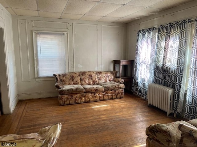 285 N Center St, City Of Orange Twp, NJ 07050 - living area with radiator, wood finished floors, a drop ceiling, and baseboards