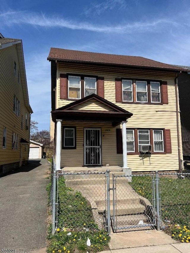 285 N Center St, City Of Orange Twp, NJ 07050 - view of front of house with a fenced front yard, covered porch, a detached garage, a gate, and an outdoor structure