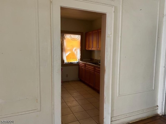 285 N Center St, City Of Orange Twp, NJ 07050 - kitchen featuring light tile patterned flooring, a sink, and brown cabinets