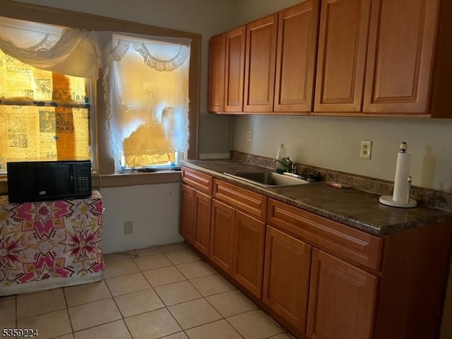 285 N Center St, City Of Orange Twp, NJ 07050 - kitchen featuring a sink, dark countertops, brown cabinets, and light tile patterned floors