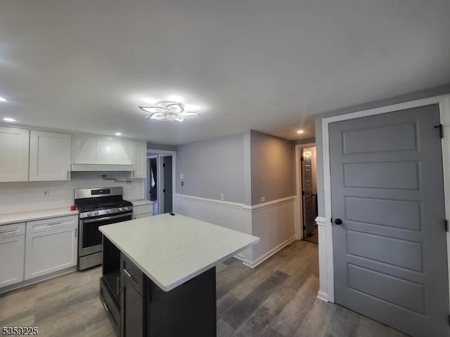 126 Seabreeze Ave, Middletown Twp, NJ 07748 - kitchen with premium range hood, stainless steel gas range, light countertops, wood finished floors, and white cabinets