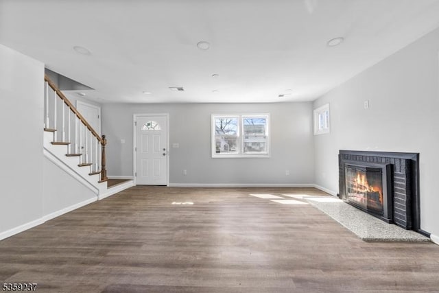 1071 Rose St, Plainfield City, NJ 07060 - unfurnished living room featuring a fireplace with flush hearth, wood finished floors, stairway, and baseboards