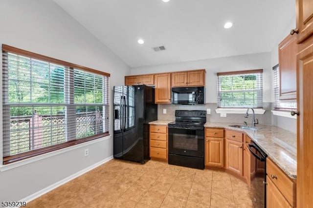 376 Finch Ln, Bedminster Twp, NJ 07921 - kitchen featuring black appliances, a sink, vaulted ceiling, tasteful backsplash, and light stone counters
