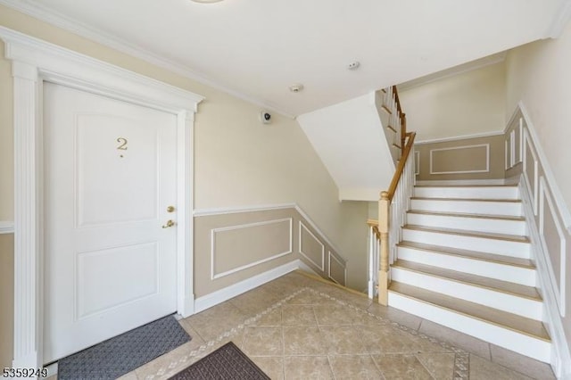 29 E Price St Unit 2, Linden City, NJ 07036 - tiled entrance foyer featuring a decorative wall, inlaid floor details, a wainscoted wall, stairway, and crown molding