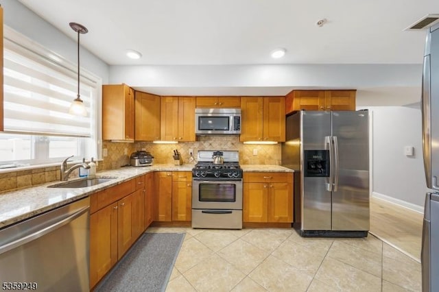 29 E Price St Unit 2, Linden City, NJ 07036 - kitchen featuring stainless steel appliances, a sink, light stone countertops, tasteful backsplash, and brown cabinets
