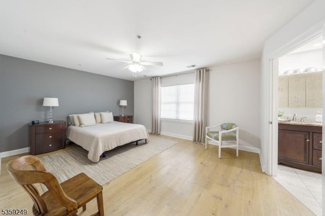 29 E Price St Unit 2, Linden City, NJ 07036 - bedroom featuring baseboards, light wood-style floors, a sink, a ceiling fan, and ensuite bath