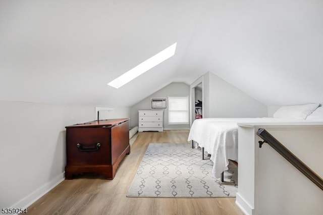 114 Hoagland Ave, Rockaway Boro, NJ 07866 - bedroom featuring a skylight, wood finished floors, vaulted ceiling, and a wall unit AC