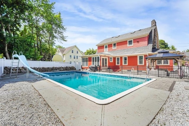 114 Hoagland Ave, Rockaway Boro, NJ 07866 - view of swimming pool with a water slide, a patio, a gazebo, a fenced backyard, and a sunroom