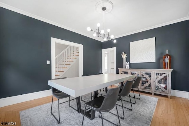 114 Hoagland Ave, Rockaway Boro, NJ 07866 - dining room featuring a chandelier, baseboards, light wood-style floors, crown molding, and stairs