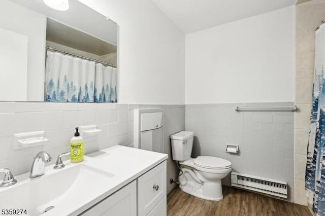 798 Eves Dr Unit 3G, Hillsborough Twp, NJ 08844 - full bathroom with tile walls, a baseboard radiator, wood finished floors, toilet, and vanity