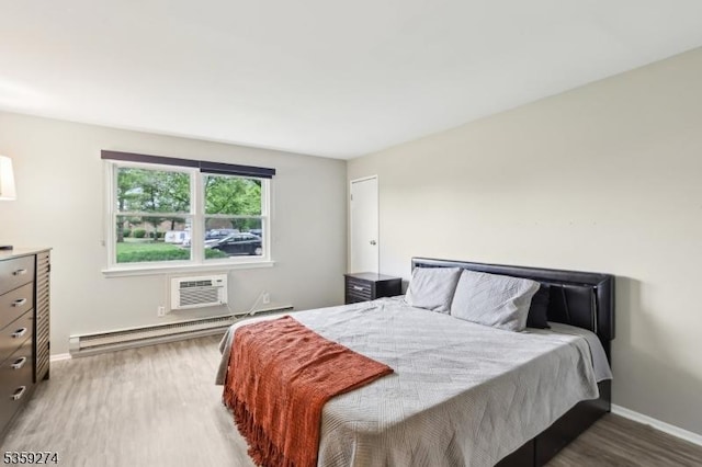 798 Eves Dr Unit 3G, Hillsborough Twp, NJ 08844 - bedroom with baseboard heating, wood finished floors, baseboards, and a wall mounted air conditioner