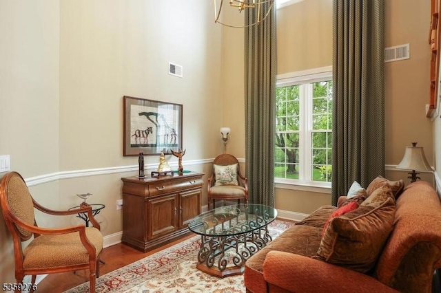 37 Hancock Pl, Franklin Twp, NJ 08873 - living area featuring baseboards, wood finished floors, a towering ceiling, and a chandelier