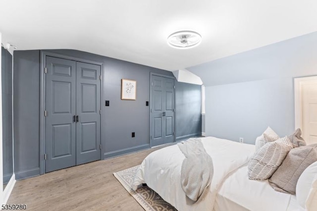 359 Dogwood Way, Mountainside Boro, NJ 07092 - bedroom with lofted ceiling, light wood finished floors, baseboards, and two closets