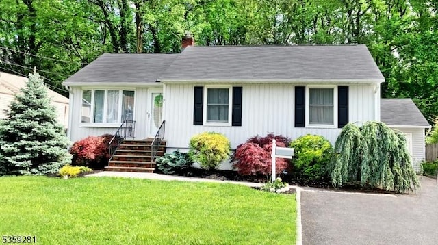 7 Park Dr, Kenilworth Boro, NJ 07033 - view of front of property with a chimney, a front lawn, and board and batten siding
