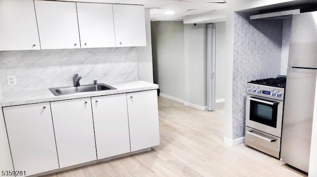 7 Park Dr, Kenilworth Boro, NJ 07033 - kitchen featuring appliances with stainless steel finishes, light countertops, a sink, baseboards, and white cabinetry