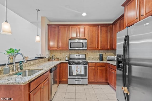 6406 Brookhaven Ct, Riverdale Boro, NJ 07457 - kitchen featuring appliances with stainless steel finishes, a sink, light tile patterned flooring, a peninsula, and light stone counters