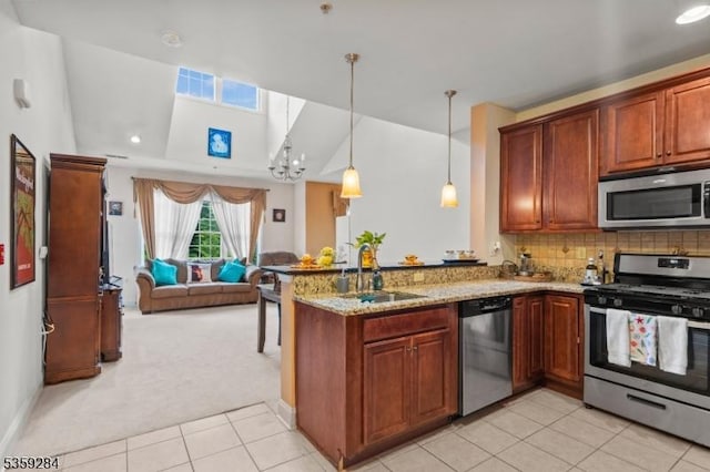 6406 Brookhaven Ct, Riverdale Boro, NJ 07457 - kitchen featuring stainless steel appliances, light colored carpet, open floor plan, a peninsula, and light stone countertops