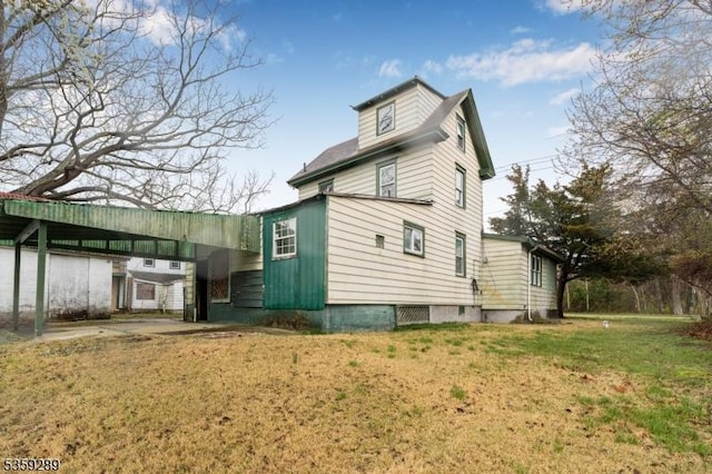 615 S New York Rd, Galloway Twp, NJ 08205 - view of side of home featuring a lawn and a carport