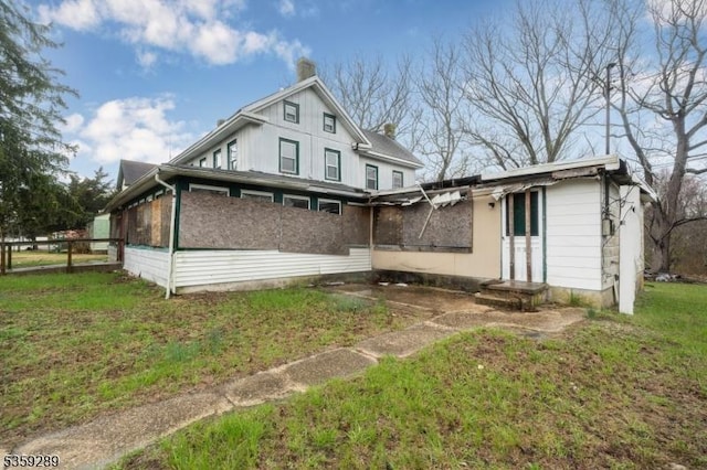 615 S New York Rd, Galloway Twp, NJ 08205 - rear view of house with a chimney and a sunroom